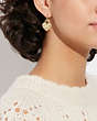 COACH®,HEART TURNLOCK PAVÉ HUGGIE EARRINGS,Brass,Gold/Pink Multi,Detail View