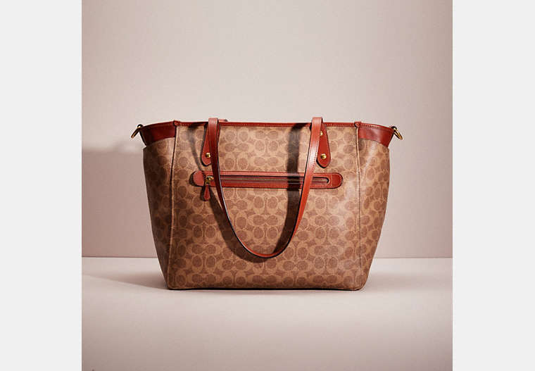 COACH®,RESTORED BABY BAG IN SIGNATURE CANVAS,Signature Coated Canvas,Brass/Tan/Rust,Front View