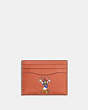 COACH®,DISNEY X COACH CARD CASE IN REGENERATIVE LEATHER,Glovetanned Leather,Burnt Coral Multi,Front View