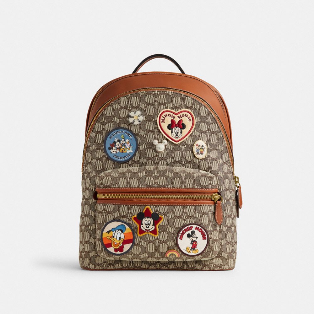 COACH®,DISNEY X COACH CHARTER BACKPACK IN SIGNATURE TEXTILE JACQUARD WITH PATCHES,X-Large,Cocoa Jacquard,Front View