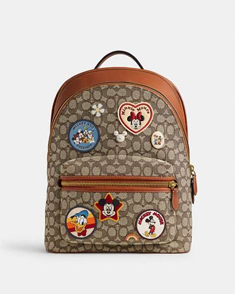 COACH®,DISNEY X COACH CHARTER BACKPACK IN SIGNATURE TEXTILE JACQUARD WITH PATCHES,Signature Jacquard,X-Large,Cocoa Jacquard,Front View