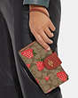 COACH®,PHONE WALLET IN SIGNATURE CANVAS WITH WILD STRAWBERRY PRINT,Gold/Khaki Multi,Detail View