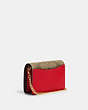 COACH®,MINI WALLET ON A CHAIN IN SIGNATURE CANVAS WITH STRAWBERRY,Leather,Mini,Im/Khaki/Electric Red,Angle View