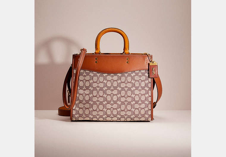 COACH®,RESTORED ROGUE IN SIGNATURE TEXTILE JACQUARD,Glovetanned Leather,Large,Brass/Cocoa Burnished Amb,Front View