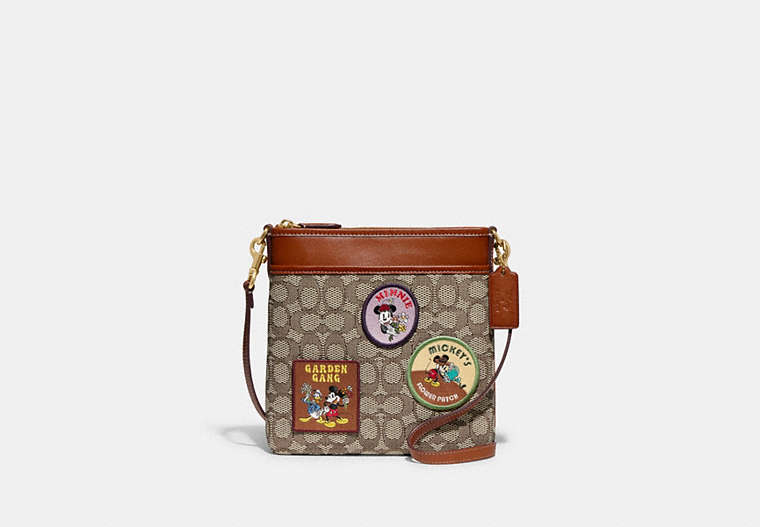 COACH®,DISNEY X COACH KITT MESSENGER CROSSBODY BAG IN SIGNATURE TEXTILE JACQUARD WITH PATCHES,Jacquard,Medium,Brass/Cocoa Burnished Amber,Front View