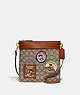 COACH®,DISNEY X COACH KITT MESSENGER CROSSBODY BAG IN SIGNATURE TEXTILE JACQUARD WITH PATCHES,Jacquard,Medium,Brass/Cocoa Burnished Amber,Front View