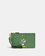 COACH®,DISNEY X COACH SMALL WRISTLET IN REGENERATIVE LEATHER WITH DONALD DUCK,Smooth Leather,Mini,Brass/Soft Green,Front View