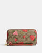COACH®,LONG ZIP AROUND WALLET IN SIGNATURE CANVAS WITH WILD STRAWBERRY PRINT,Mini,Gold/Khaki Multi,Front View