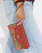 COACH®,TRAVEL ENVELOPE WALLET IN SIGNATURE CANVAS WITH WILD STRAWBERRY PRINT,Gold/Khaki Multi,Detail View