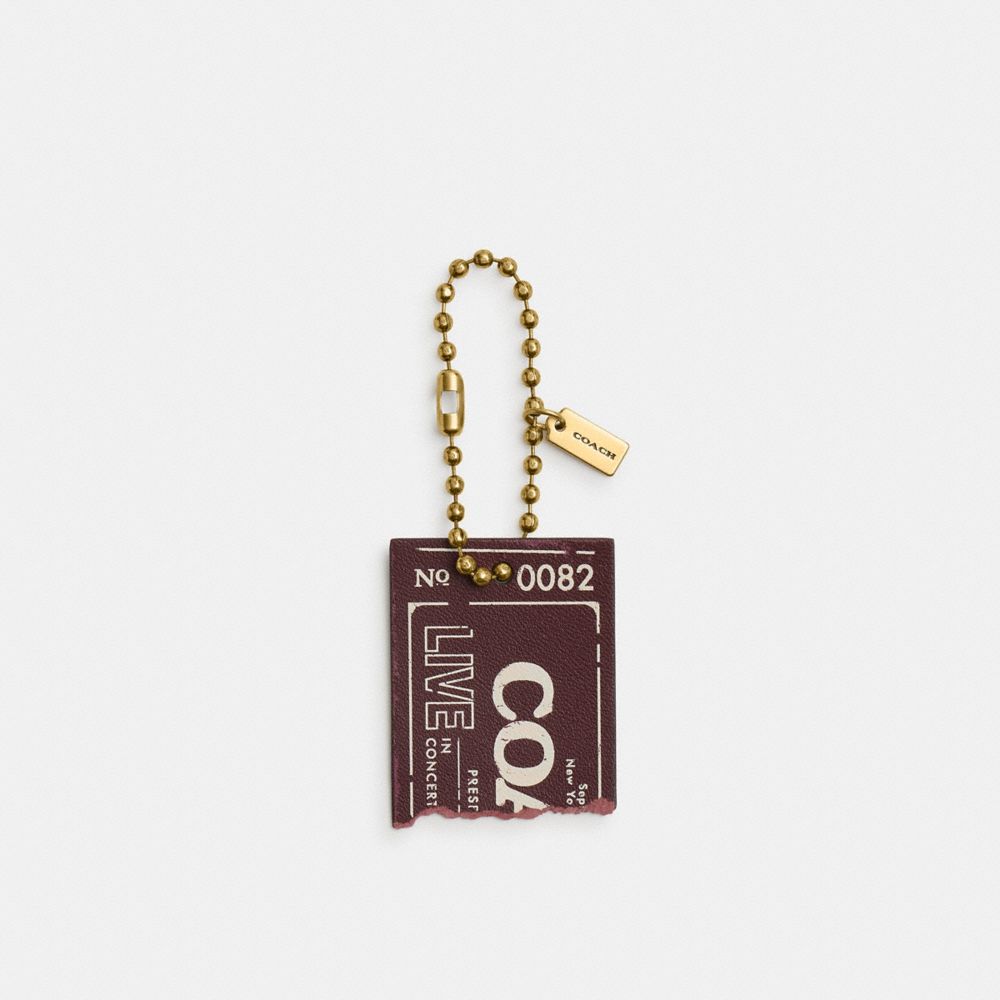 COACH®,Live In Concert Concert Ticket Bag Charm,Key Chain,Metal Material,Leather,Lettering Word,ID Tag,Brass,Maroon,Front View