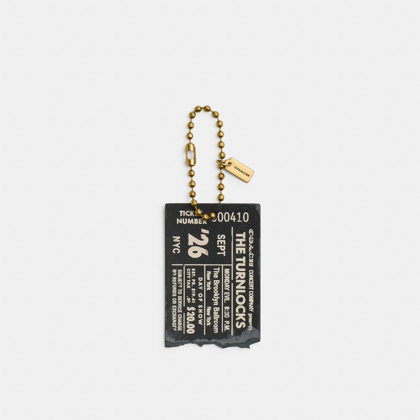 Женский брелок Coach The Turnlocks Concert Ticket Bag Charm, цвет: Латунный / Чёрный — фото 1