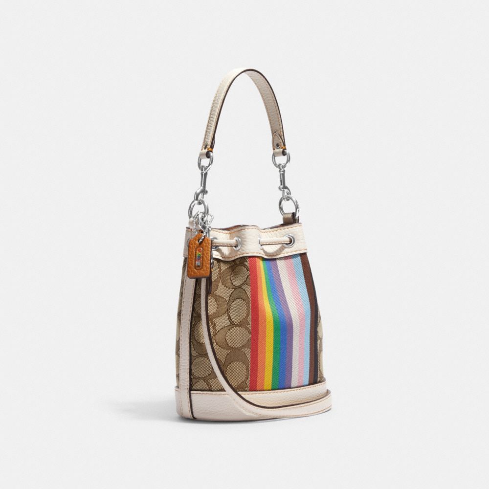 COACH®,Mini Dempsey Bucket Bag In Signature Jacquard With Rainbow Stripe And Coach Patch,,Angle View