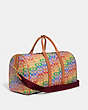 COACH®,GOTHAM DUFFLE BAG IN RAINBOW SIGNATURE CANVAS,Signature Coated Canvas,X-Large,Burnished Amber Multicolor,Angle View