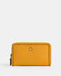 COACH®,MEDIUM ZIP AROUND WALLET WITH BRAID,Polished Pebble Leather,Small,Brass/Buttercup,Front View