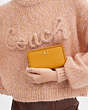 COACH®,MEDIUM ZIP AROUND WALLET WITH BRAID,Polished Pebble Leather,Small,Brass/Buttercup,Detail View