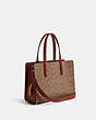COACH®,CARTER CARRYALL 28 IN SIGNATURE CANVAS,Signature Coated Canvas,Medium,Brass/Tan/Rust,Angle View