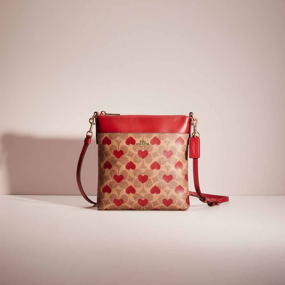 COACH®,RESTORED KITT MESSENGER CROSSBODY IN SIGNATURE CANVAS WITH HEART PRINT,Signature Coated Canvas,Medium,Brass/Tan Red Apple,Front View