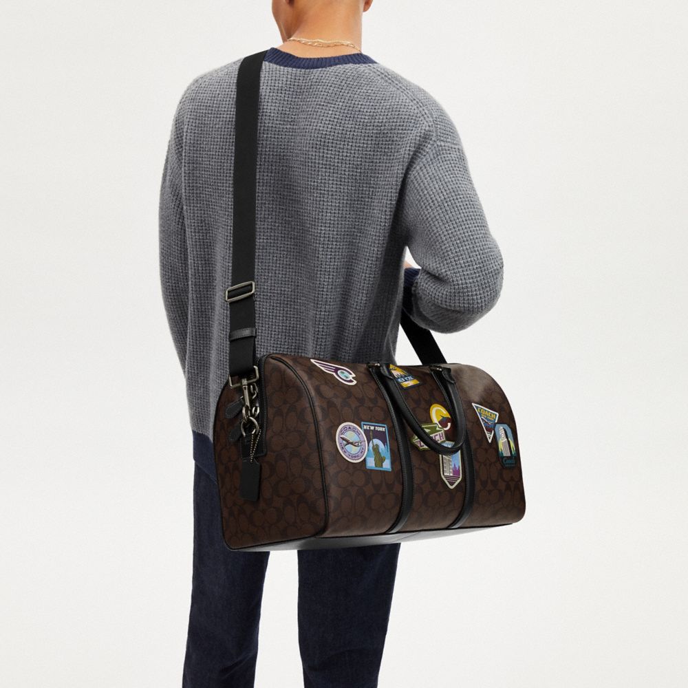 COACH®,Venturer Bag In Signature Canvas With Travel Patches,Calfskin Leather,Canvas,Duffle Bag,PVC,Graphic,Applique,Logo,G...,Brown,Detail View