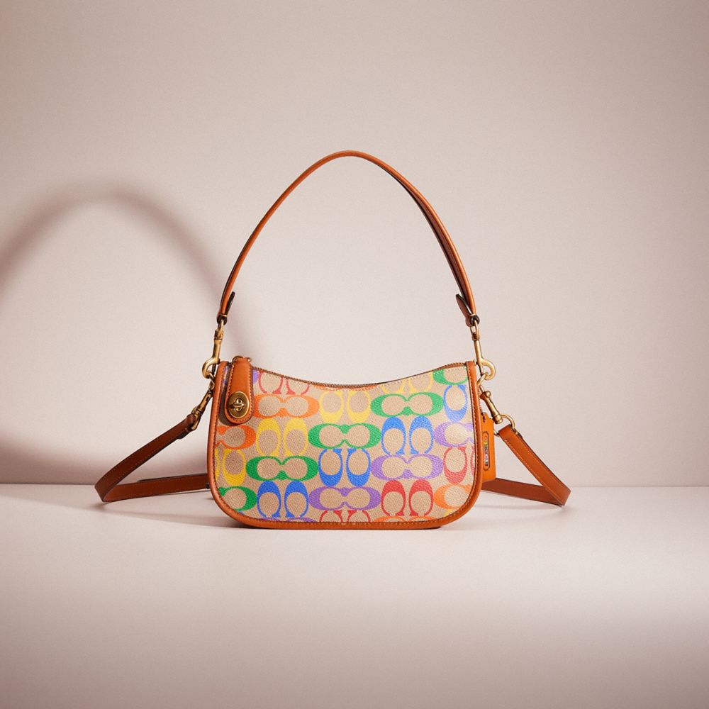 COACH®,RESTORED SWINGER IN RAINBOW SIGNATURE CANVAS,Signature Coated Canvas,Small,Brass/Tan Hazelnut Multi,Front View