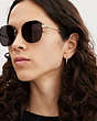 COACH®,HINGED GEOMETRIC ROUND SUNGLASSES,Antique Gold/ Wine,Angle View
