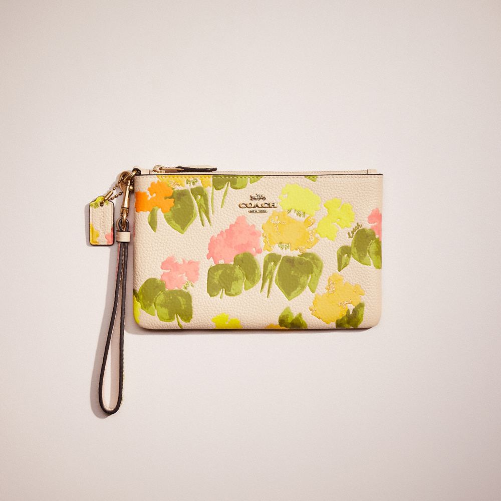 COACH®,RESTORED SMALL WRISTLET WITH FLORAL PRINT,Polished Pebble Leather,Mini,Brass/Multi,Front View