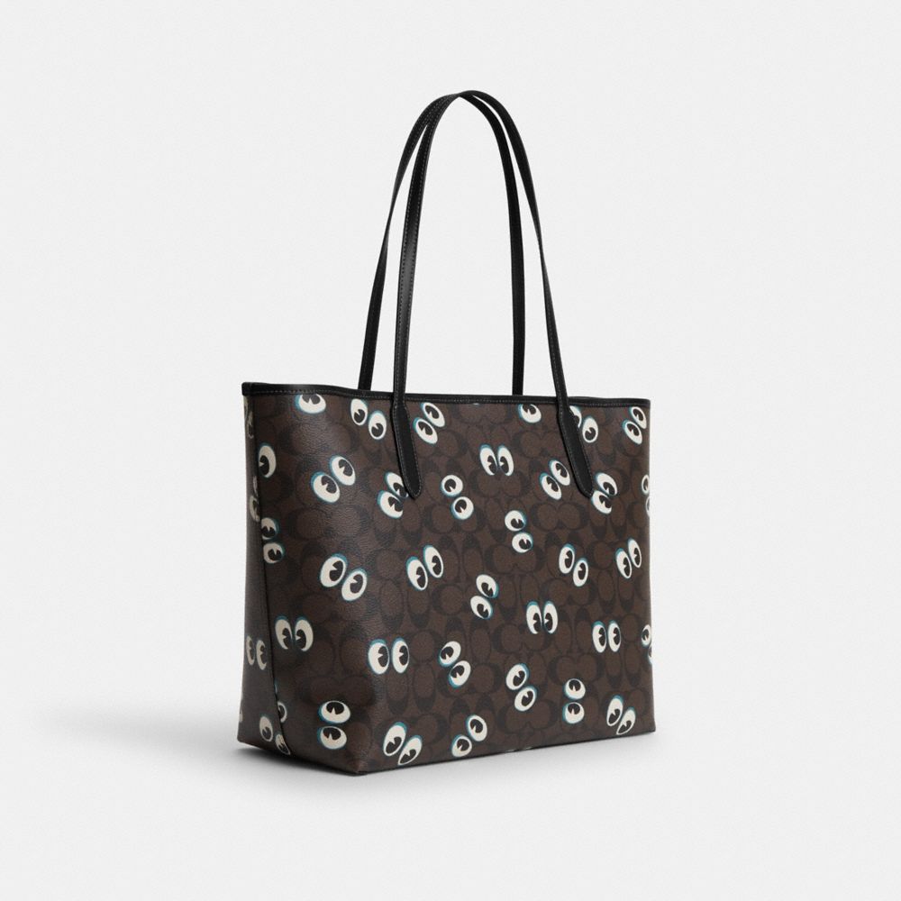 COACH®,CITY TOTE BAG IN SIGNATURE CANVAS WITH HALLOWEEN EYES,Signature Canvas,X-Large,Silver/Brown Black Multi,Angle View