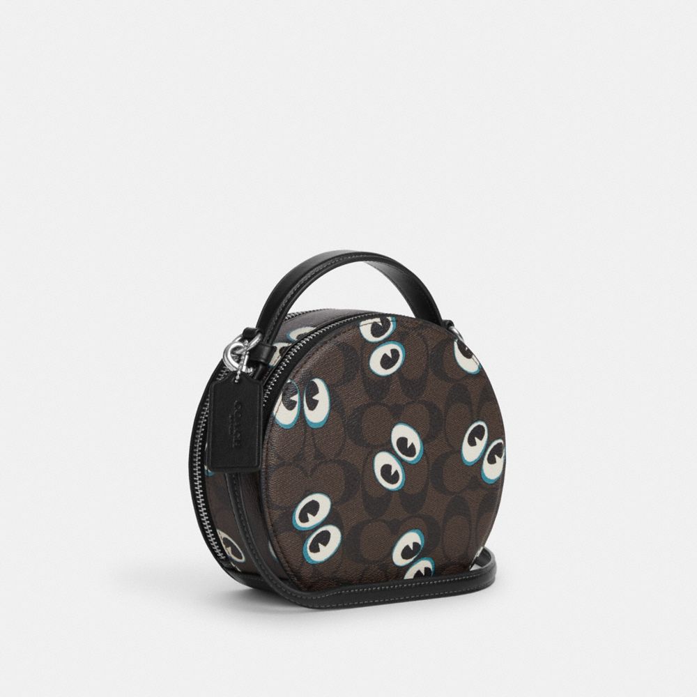 COACH®,CANTEEN CROSSBODY BAG IN SIGNATURE CANVAS WITH HALLOWEEN EYES,Signature Canvas,Small,Silver/Brown Black Multi,Angle View