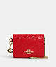 COACH®,BOXED MINI WALLET ON A CHAIN IN SIGNATURE LEATHER,Embossed Leather,Gold/Electric Red,Front View