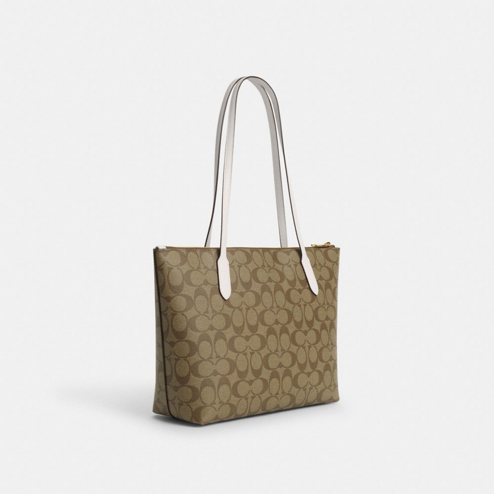 COACH®,ZIP TOP TOTE BAG IN SIGNATURE CANVAS WITH HORSE AND SLEIGH,Signature Canvas,Medium,Gold/Khaki/Chalk,Angle View