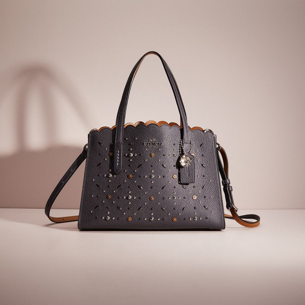 Coach charlie carryall store with rivets