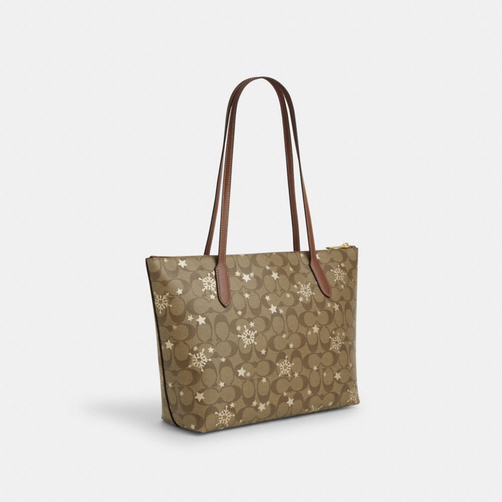 COACH®,ZIP TOP TOTE BAG IN SIGNATURE CANVAS WITH STAR AND SNOWFLAKE PRINT,Signature Canvas,Medium,Im/Khaki Saddle/Gold Multi,Angle View