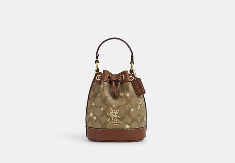 COACH®,DEMPSEY DRAWSTRING BUCKET BAG 15 IN SIGNATURE CANVAS WITH STAR AND SNOWFLAKE PRINT,Coated Canvas,Medium,Im/Khaki Saddle/Gold Multi,Front View image number 0