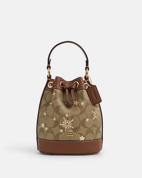 COACH®,DEMPSEY DRAWSTRING BUCKET BAG 15 IN SIGNATURE CANVAS WITH STAR AND SNOWFLAKE PRINT,Coated Canvas,Medium,Im/Khaki Saddle/Gold Multi,Front View