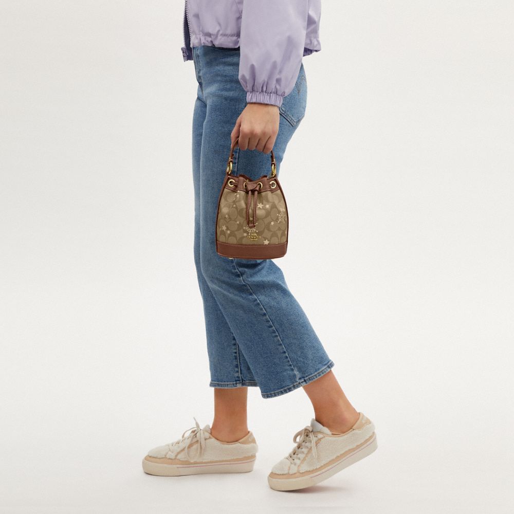 COACH®,Dempsey Drawstring Bucket Bag 15 In Signature Canvas With Star And Snowflake Print,,Detail View