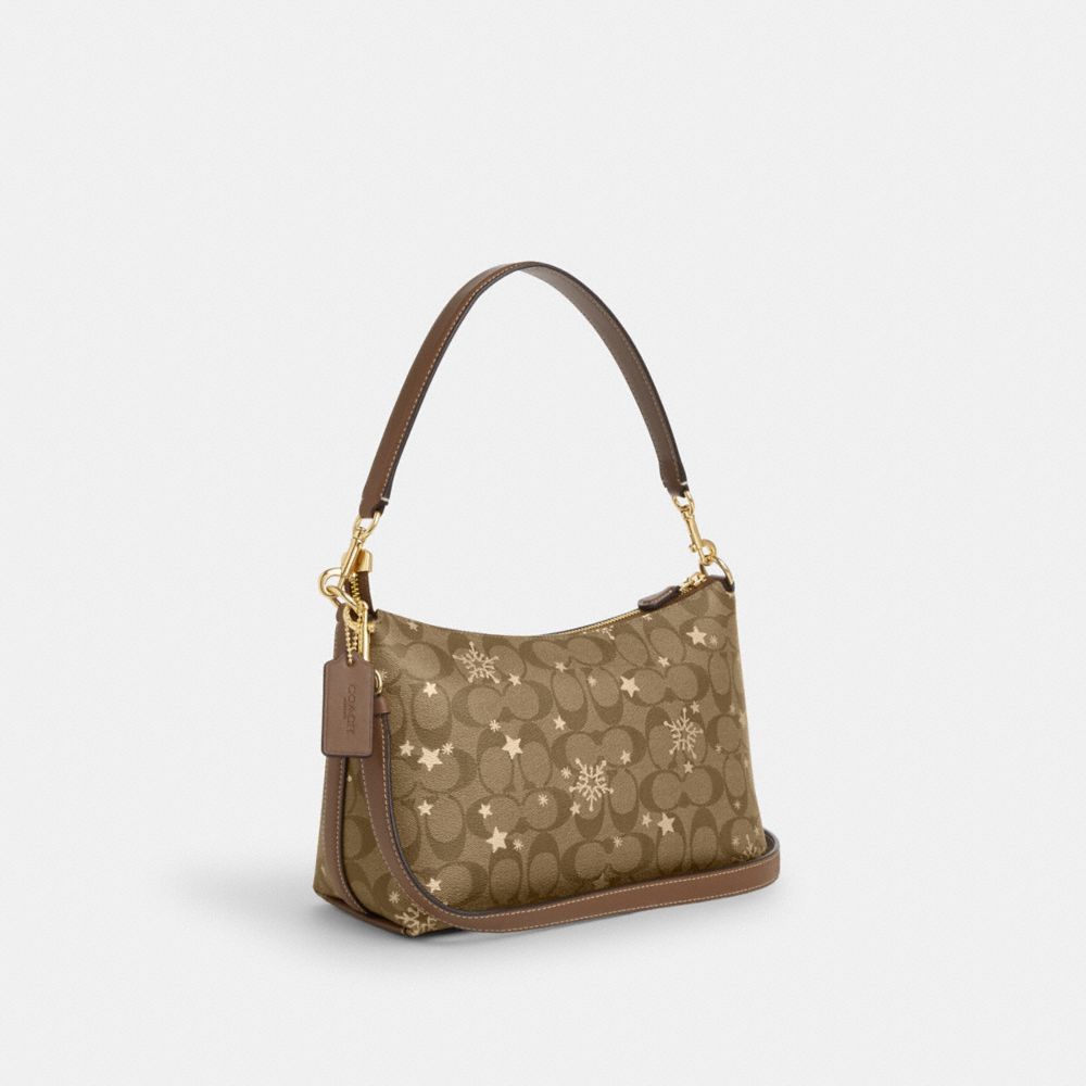 COACH®,CLARA SHOULDER BAG IN SIGNATURE CANVAS WITH STAR AND SNOWFLAKE PRINT,Signature Canvas,Medium,Im/Khaki Saddle/Gold Multi,Angle View