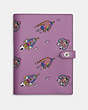 COACH®,COSMIC COACH NOTEBOOK WITH ROCKET PRINT,Glovetanned Leather,Silver/Violet Orchid Multi,Front View