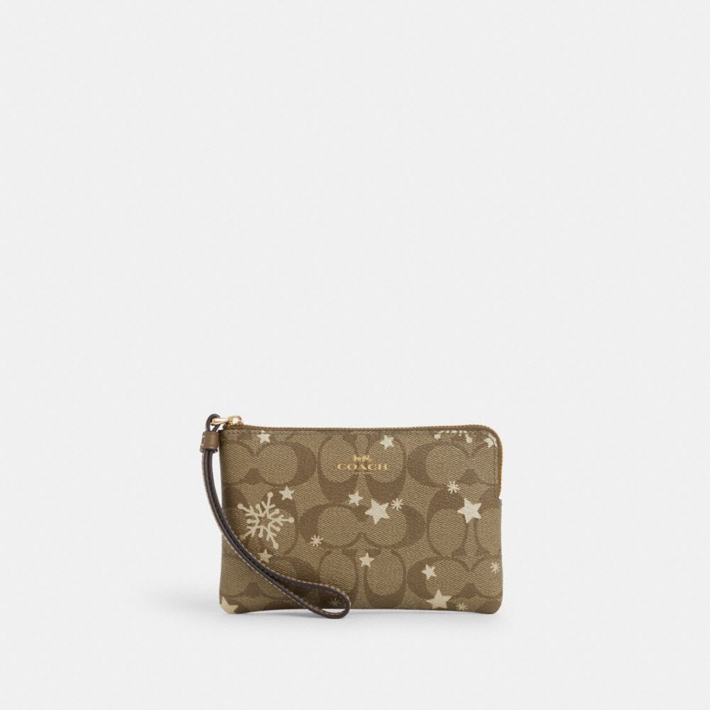 COACH®,CORNER ZIP WRISTLET IN SIGNATURE CANVAS WITH STAR AND SNOWFLAKE PRINT,Signature Canvas,Mini,Im/Khaki Saddle/Gold Multi,Front View