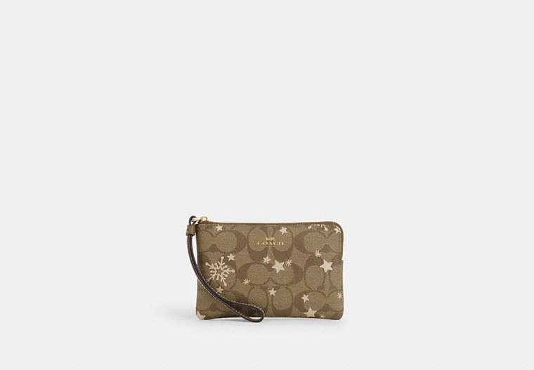 COACH®,CORNER ZIP WRISTLET IN SIGNATURE CANVAS WITH STAR AND SNOWFLAKE PRINT,Coated Canvas,Mini,Im/Khaki Saddle/Gold Multi,Front View image number 0