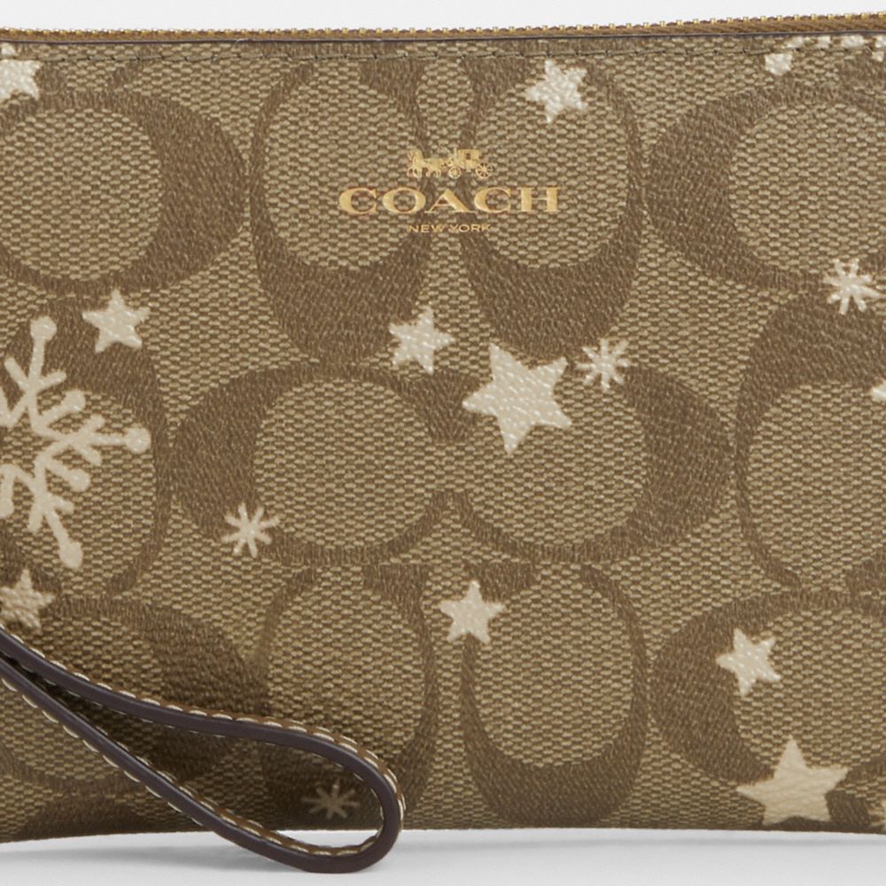 COACH®,CORNER ZIP WRISTLET IN SIGNATURE CANVAS WITH STAR AND SNOWFLAKE PRINT,Signature Canvas,Mini,Im/Khaki Saddle/Gold Multi