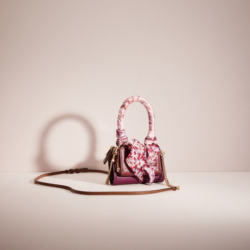 COACH®,Upcrafted Top Handle Creation,Leather,Crossbody,Bi Fold,Pattern,Studded,Chain Detail,Logo,Metal,Embellished,Sustain...,Maroon,Angle View