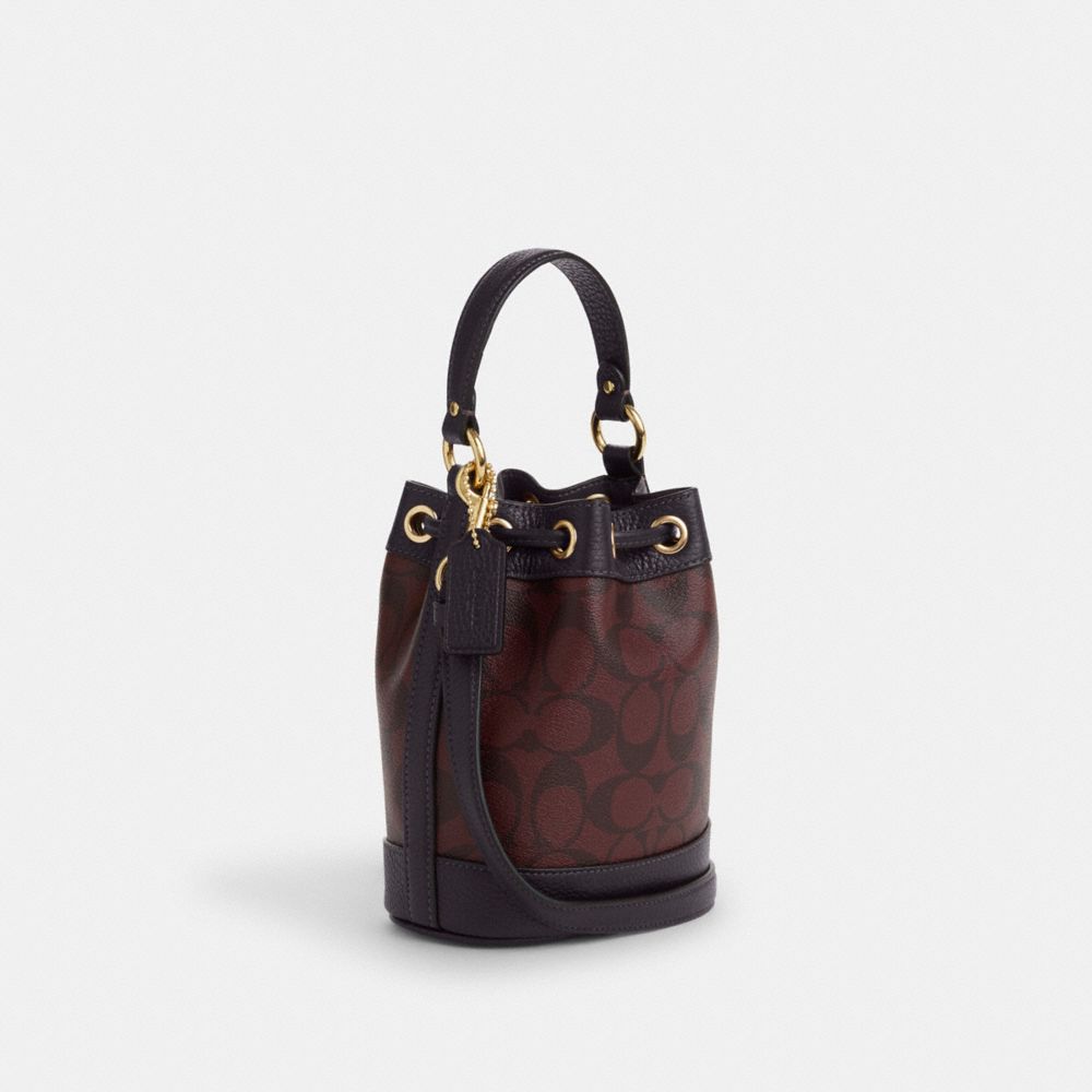 COACH®,DEMPSEY DRAWSTRING BUCKET BAG 15 IN SIGNATURE CANVAS,Signature Canvas,Medium,Gold/Oxblood Multi,Angle View