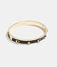 COACH®,SIGNATURE AND STONE HINGED BANGLE,Metal,Gold/Black,Front View
