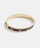 COACH®,SIGNATURE AND STONE HINGED BANGLE,Metal,Gold/Wine,Front View