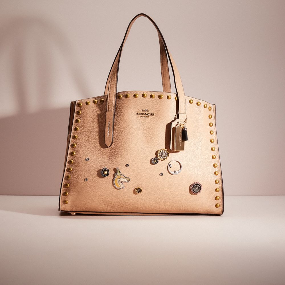 Coach charlie carryall store with rivets