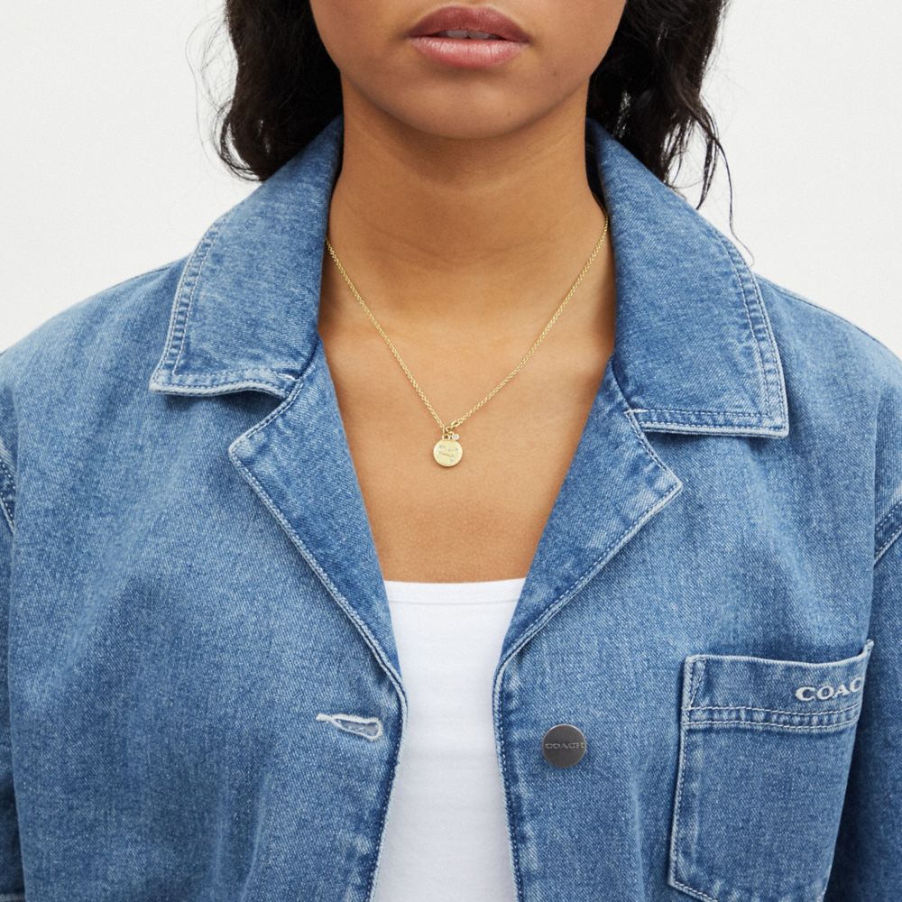 COACH®,Gemini Coin Pendant Necklace,Single Strand,Cubic Zirconia,Glass,Disc,Logo,Rhinestones,Lettering Word,Gold Plated,Ca...,Clear,Detail View