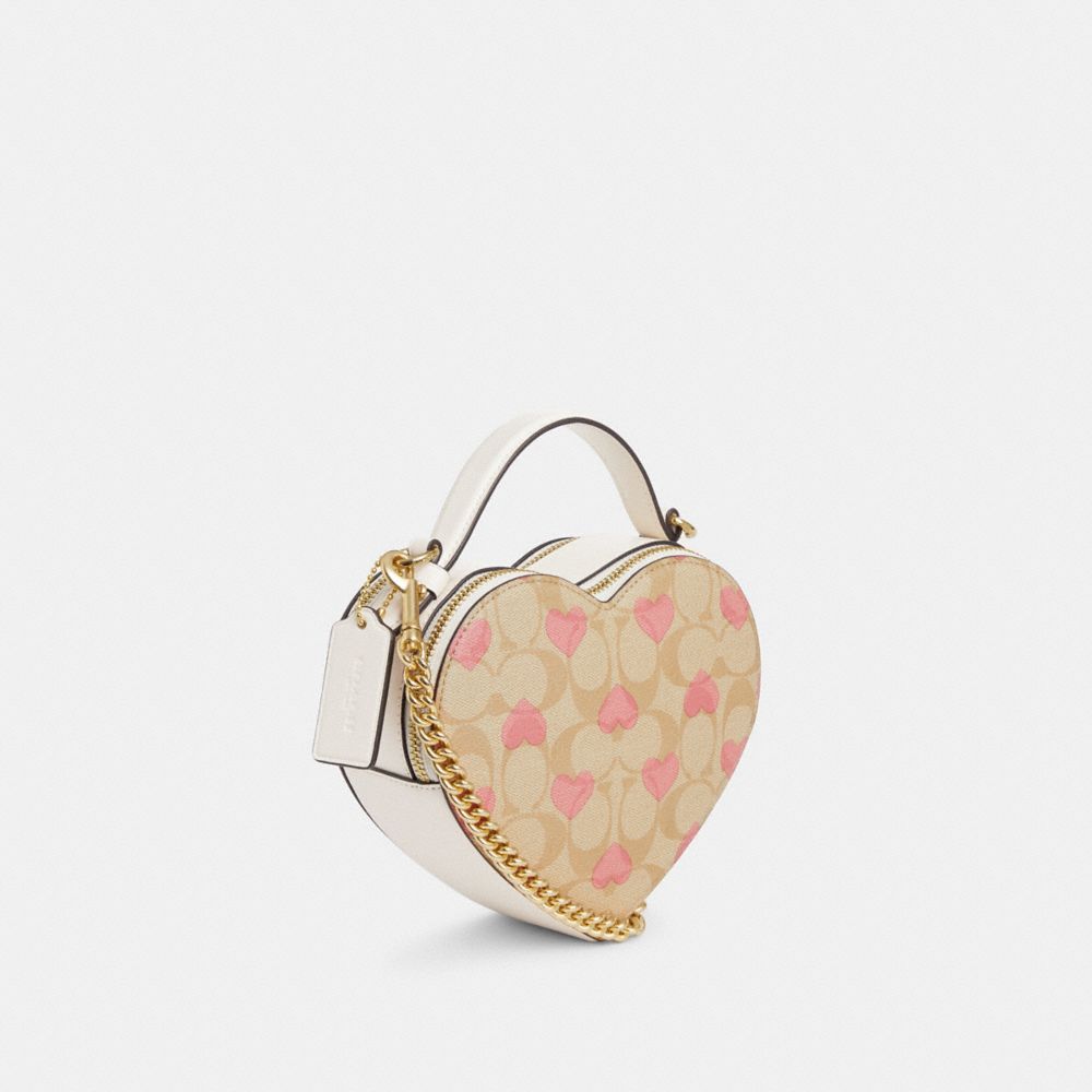 COACH®,HEART CROSSBODY IN SIGNATURE CANVAS WITH HEART PRINT,Signature Canvas,Small,Gold/Light Khaki Chalk Multi,Angle View