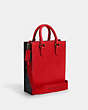 COACH®,DYLAN TOTE IN COLORBLOCK SIGNATURE CANVAS,Silk,Medium,Black Antique Nickel/Bright Poppy/Charcoal,Angle View