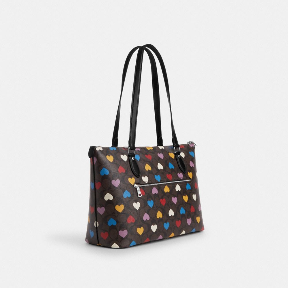 COACH®,GALLERY TOTE BAG IN SIGNATURE CANVAS WITH HEART PRINT,Signature Canvas,Large,Silver/Brown Black Multi,Angle View