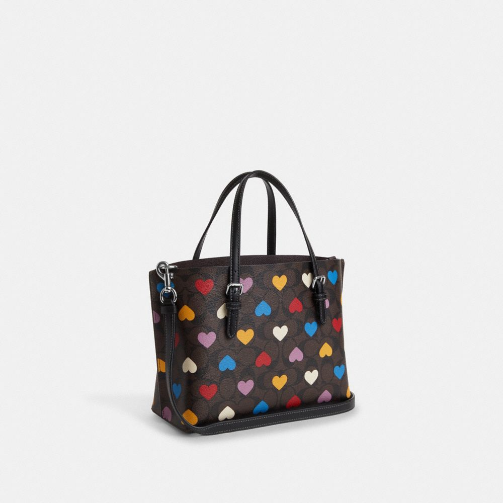 COACH®,MOLLIE TOTE BAG 25 IN SIGNATURE CANVAS WITH HEART PRINT,Signature Canvas,Medium,Silver/Brown Black Multi,Angle View
