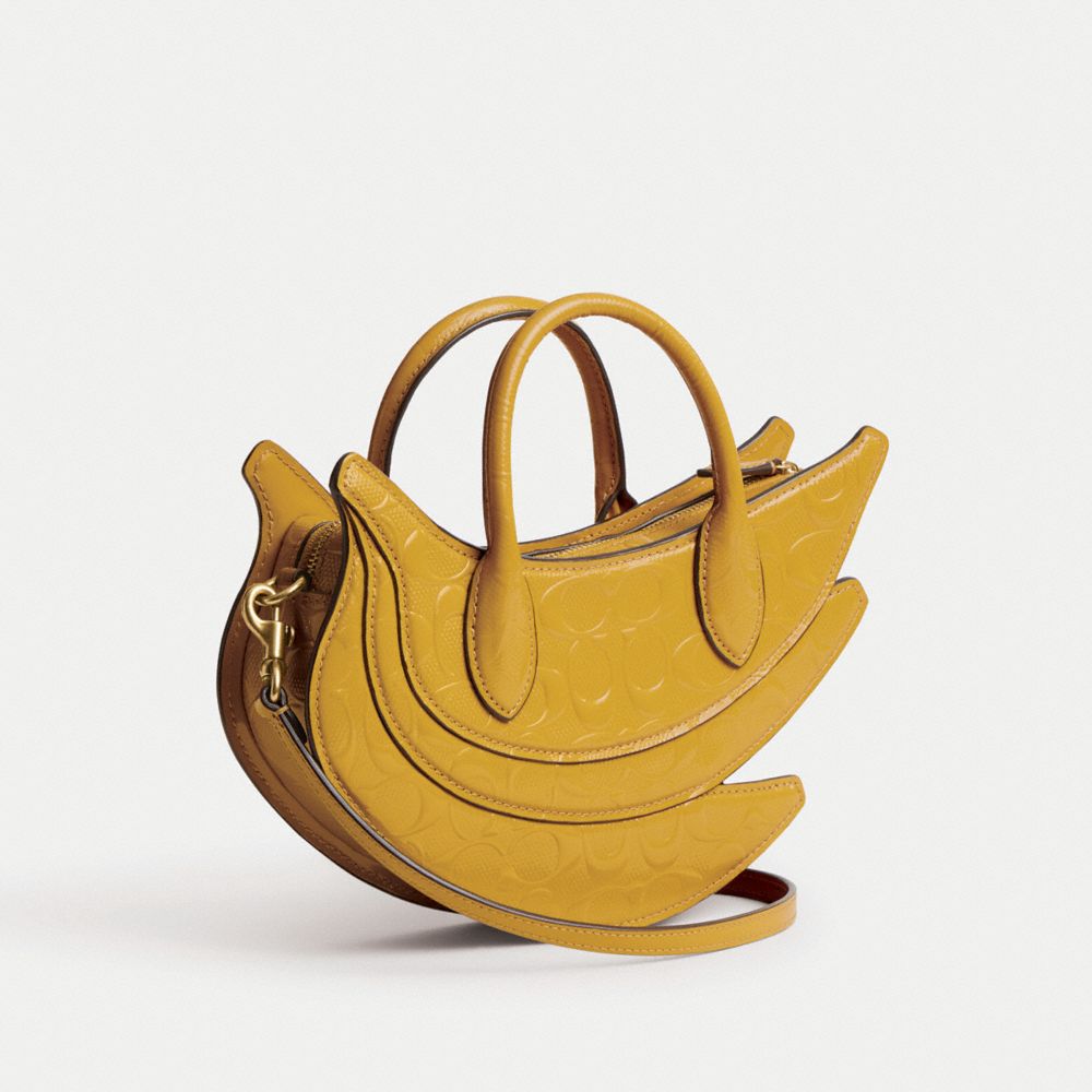 COACH®,BANANA BAG IN SIGNATURE LEATHER,Patent Leather,Medium,Brass/Gold,Angle View